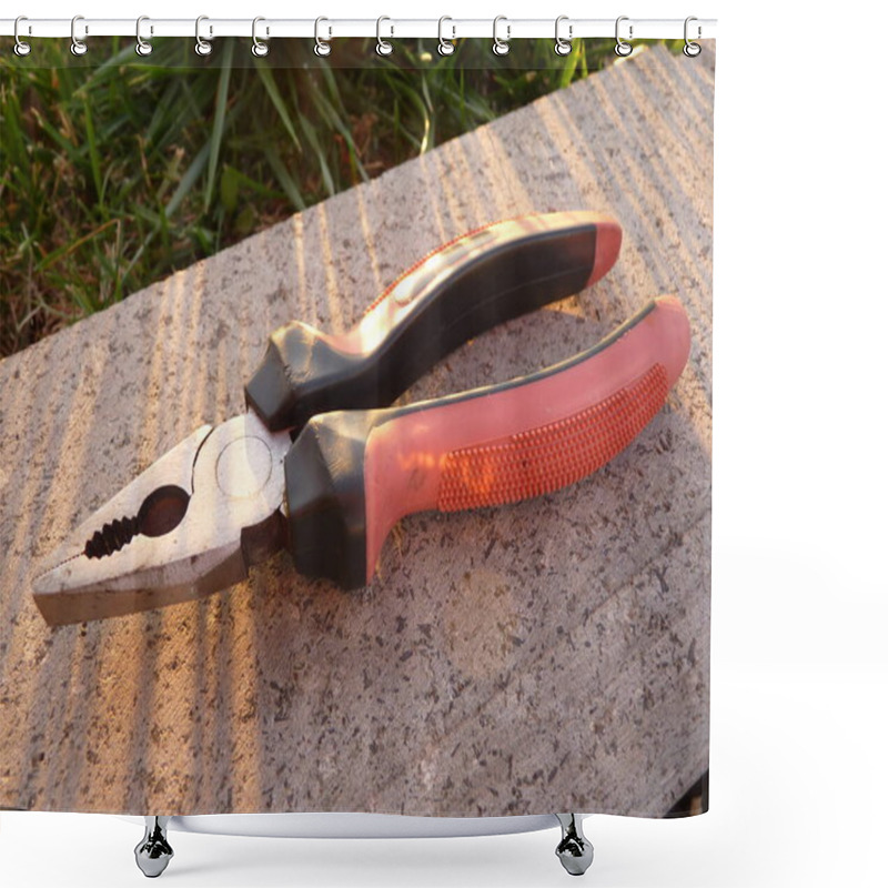 Personality  Red-Edged Pliers On A Stone Surface: A Precision Tool For Cutting Shower Curtains