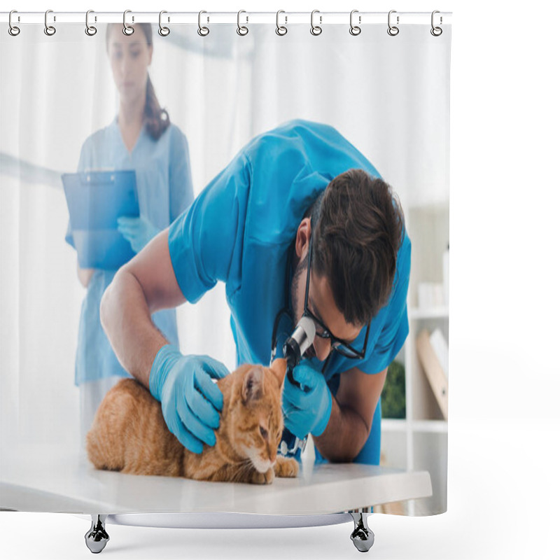 Personality  Selective Focus Of Veterinarian Examining Ears Of Red Cat With Otoscope While Colleague Writing On Clipboard Shower Curtains