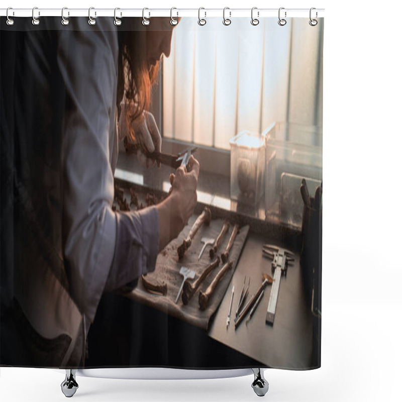 Personality  Female Scientist Or Archaeologist Measures Bone Using Tool, Examines Remains Of Ancient Human Or Dinosaur Skeleton. Fossil Specimen Collection In Advanced Archaeological Lab. Sunset Light. Slow Motion Shower Curtains