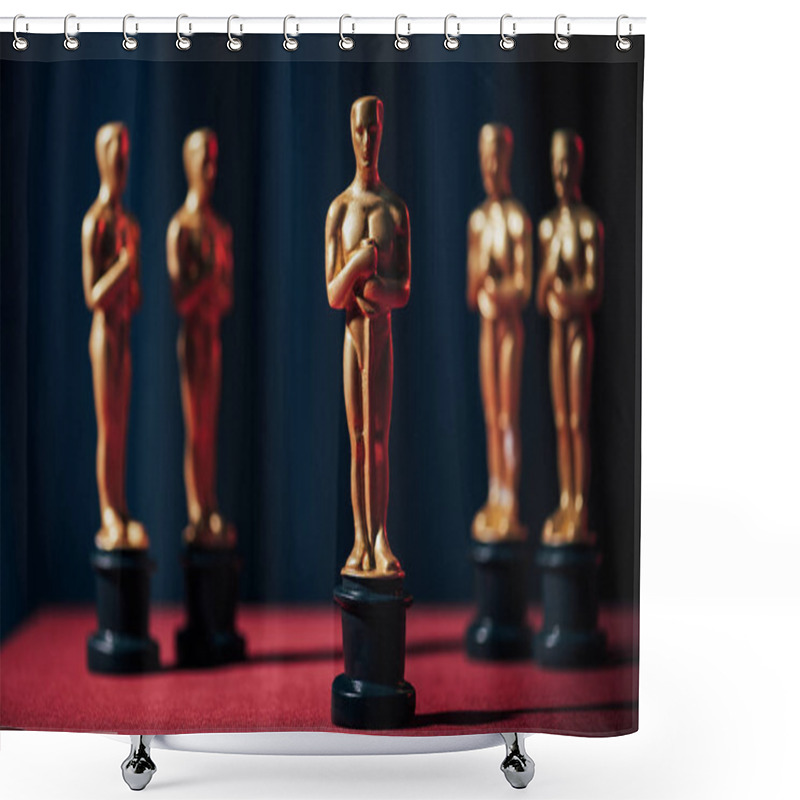 Personality  KYIV, UKRAINE - JANUARY 10, 2019: Row Of Hollywood Golden Oscar Awards On Dark Background Shower Curtains