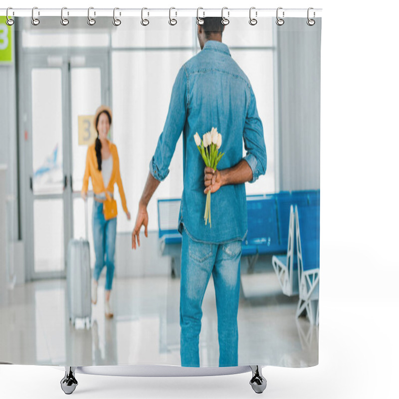 Personality  Selective Focus Of African American Man Walking Towards Happy Girlfriend With Suitcase While Hiding Tulips Behind His Back In Airport Shower Curtains