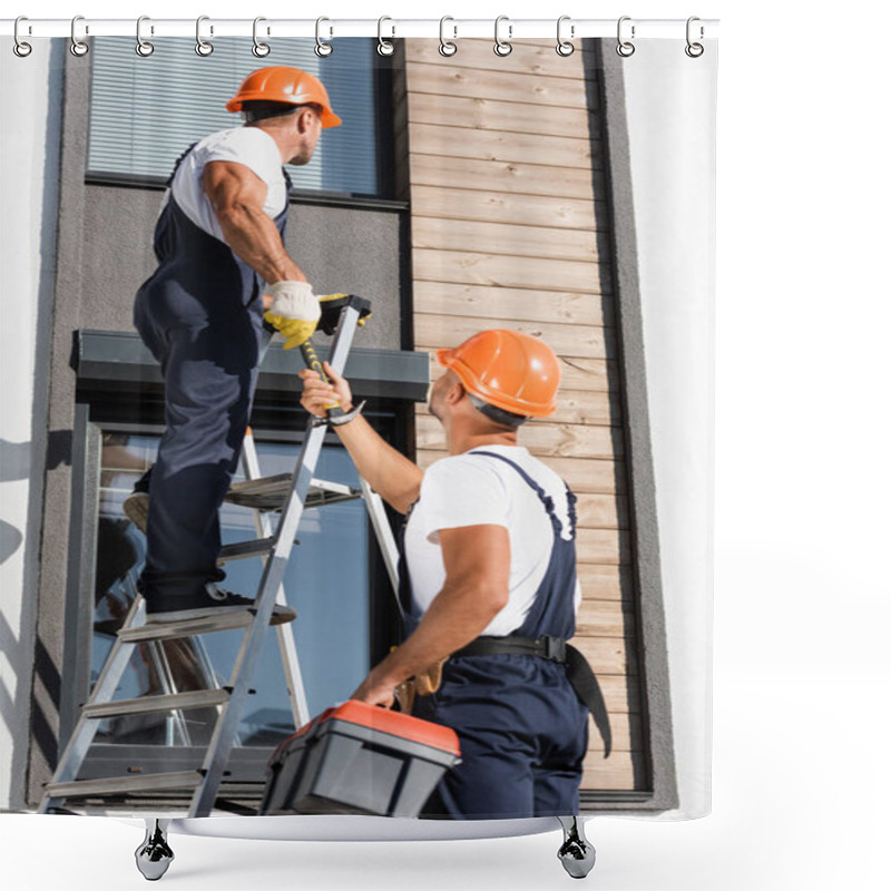 Personality  Selective Focus Of Workman With Toolbox Giving Hammer To Colleague On Ladder Near Building  Shower Curtains