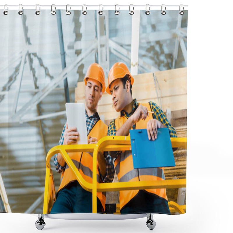 Personality  Thoughtful Multicultural Workers Using Digital Tablet While Standing On Scissor Lift In Warehouse Shower Curtains