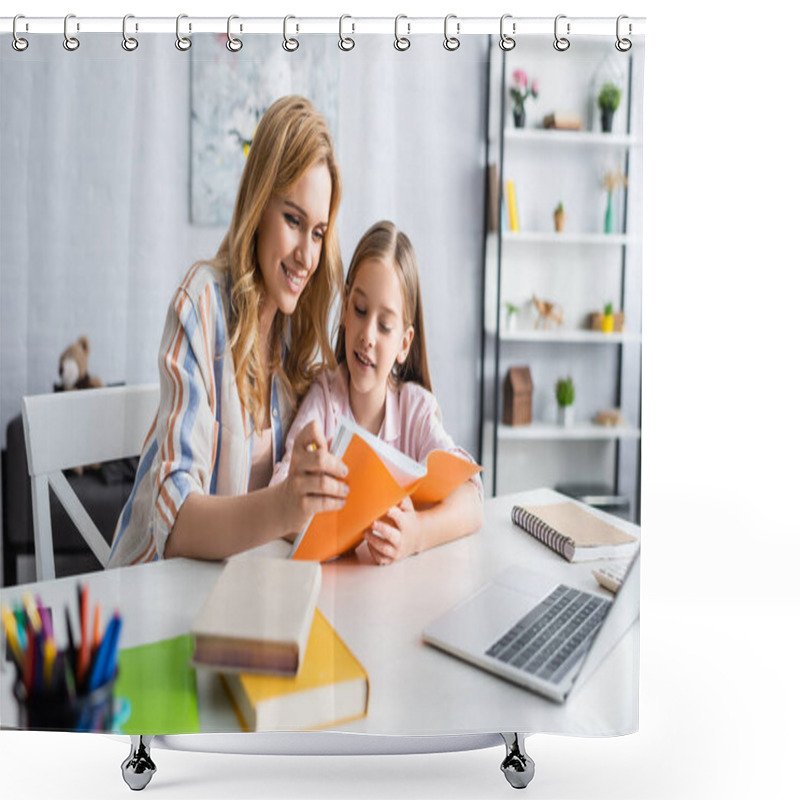 Personality  Selective Focus Of Smiling Woman Holding Notebook While Helping Daughter During Online Education At Home   Shower Curtains