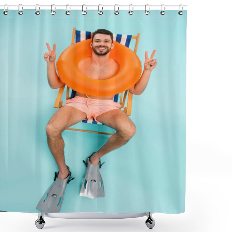 Personality  High Angle View Of Shirtless Man In Inflatable Ring And Swimming Flippers Showing Peace On Blue Background  Shower Curtains