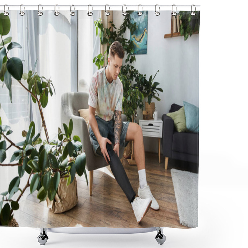 Personality  A Young Handsome Man Sits In A Modern Chair, Adjusting His Prosthetic Leg Among Houseplants. Shower Curtains