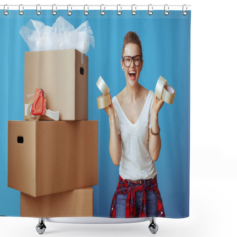 Personality  Smiling Young Woman In White T-shirt Near Cardboard Box Showing Adhesive Tapes Against Blue Background Shower Curtains