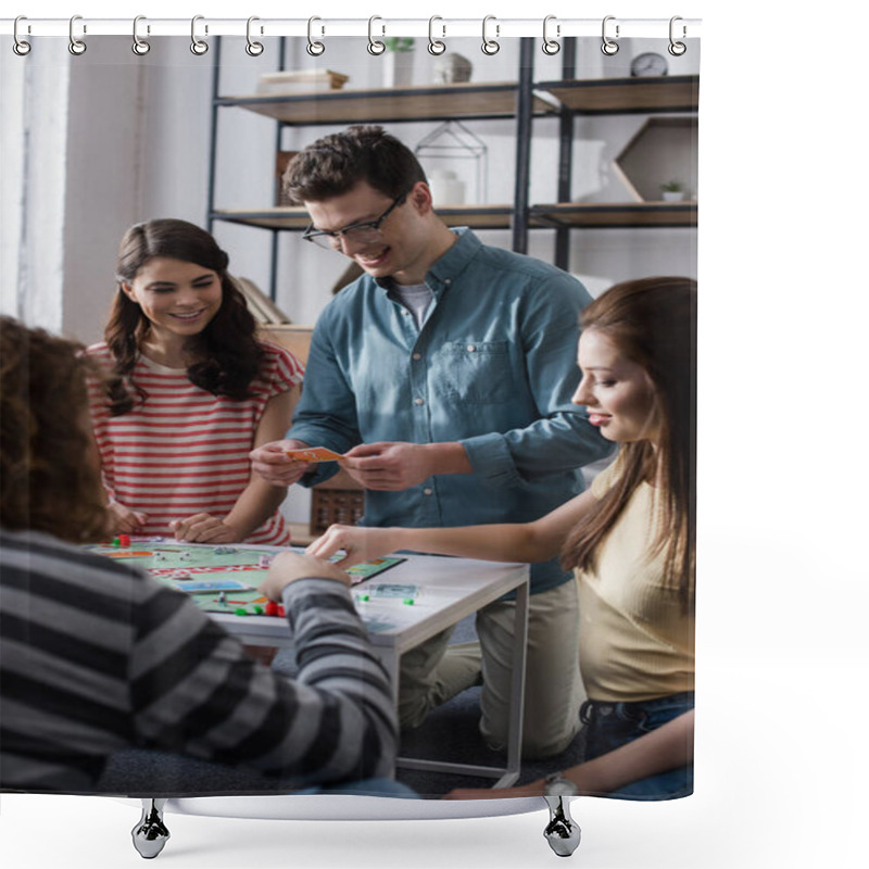 Personality  KYIV, UKRAINE - JANUARY 27, 2020: Cheerful Man Holding Card While Playing Monopoly Game With Smiling Friends Shower Curtains