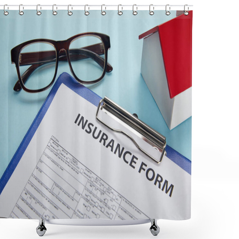 Personality  Close-up View Of Insurance Form On Clipboard, Eyeglasses And House Model On Blue Shower Curtains