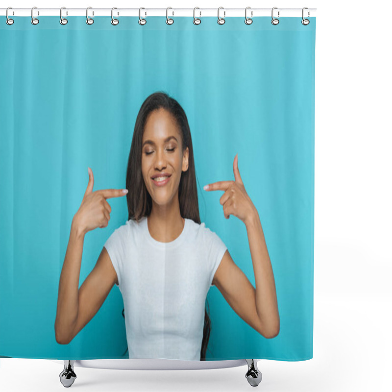 Personality  Happy African American Girl With Closed Eyes Pointing At Dental Braces On Her Teeth Isolated On Blue Shower Curtains