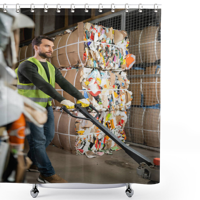 Personality  Bearded Male Worker In Protective Vest And Gloves Using Hand Pallet Truck While Standing Near Waste Paper In Garbage Sorting Center, Waste Sorting And Recycling Concept Shower Curtains