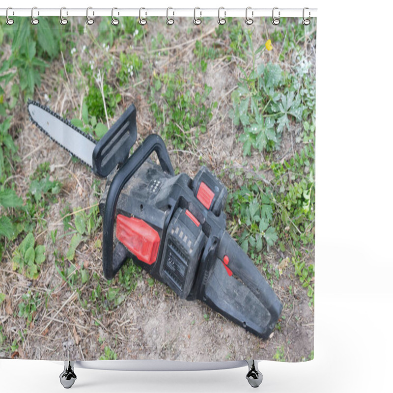 Personality  Cordless Saw Lies On The Grass. Electric Saw For Woodworking, Saw With Removable Batteries. Shower Curtains