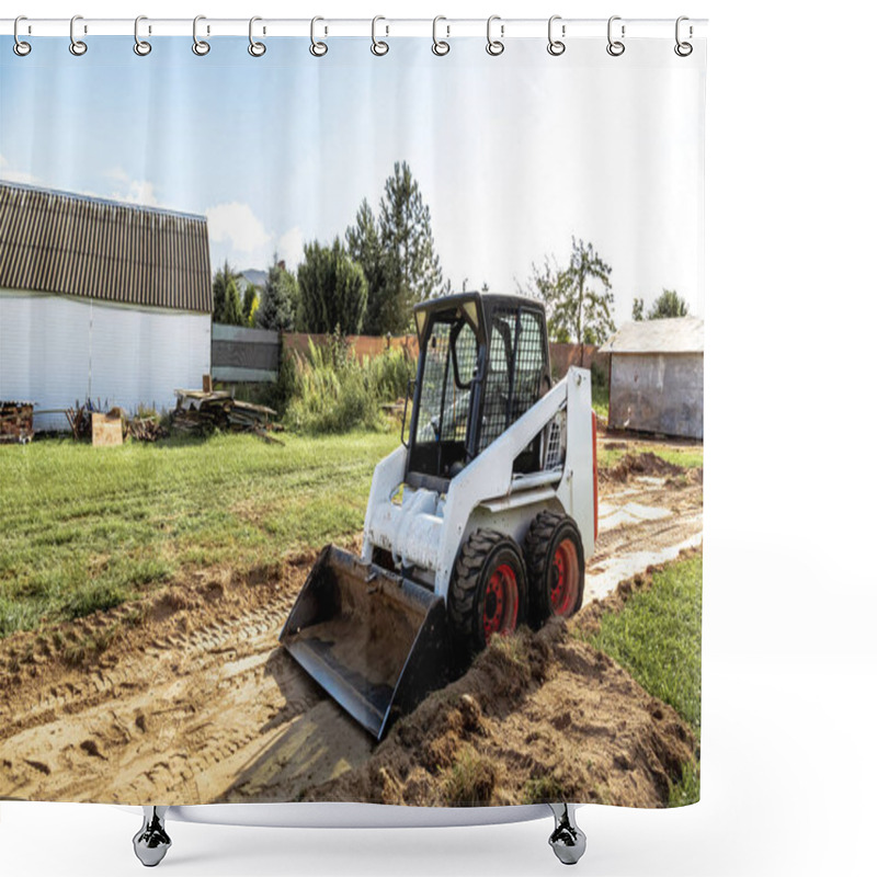 Personality  A Skid Steer Loader Clears The Site For Construction. Land Work By The Territory Improvement. Machine For Work In Confined Areas. Small Tractor With A Bucket For Moving Soil, Turf And Bulk Materials. Shower Curtains