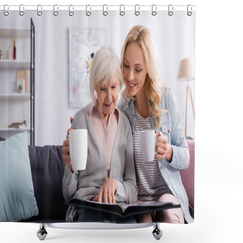 Personality  Smiling Elderly Woman With Cup Looking At Photo Album Near Daughter  Shower Curtains