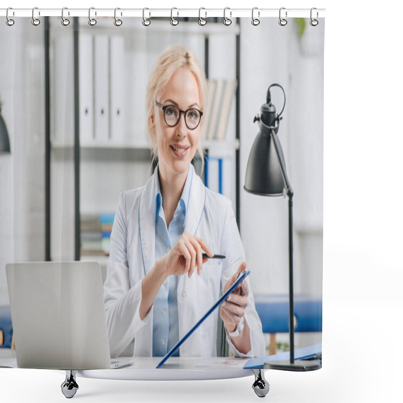 Personality  Portrait Of Smiling Chiropractor In Eyeglasses And White Coat Pointing At Notepad At Workplace In Clinic Shower Curtains