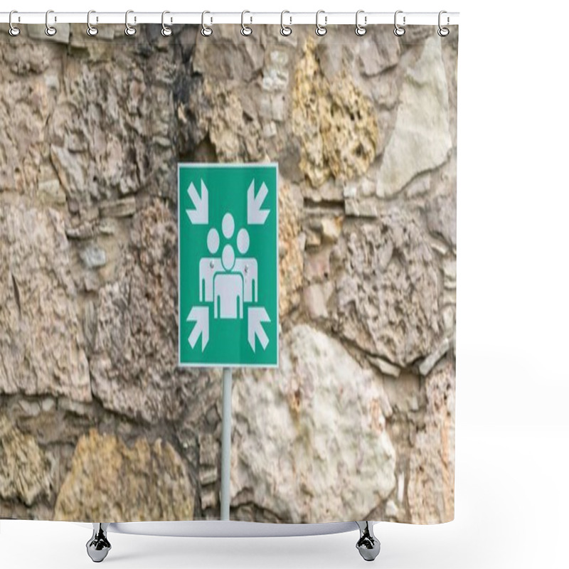 Personality  Green Assembly Point Sign Indicating A Safe Gathering Area, Mounted Against A Textured Stone Wall For Emergency Situations. Shower Curtains