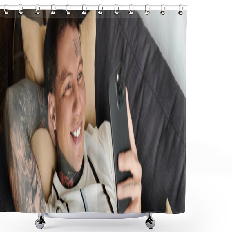 Personality  Relaxing Young Man With Tattoos Smiles As He Looks At His Phone On A Comfortable Couch. Shower Curtains