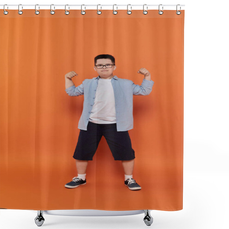 Personality  A Young Boy With Down Syndrome Flexes His Muscles In Front Of An Orange Background. Shower Curtains