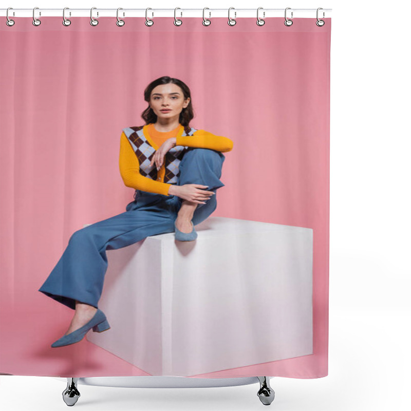 Personality  Full Length Of Woman In Blue Pants And Trendy Cardigan Sitting On White Cube And Looking At Camera On Pink Background Shower Curtains