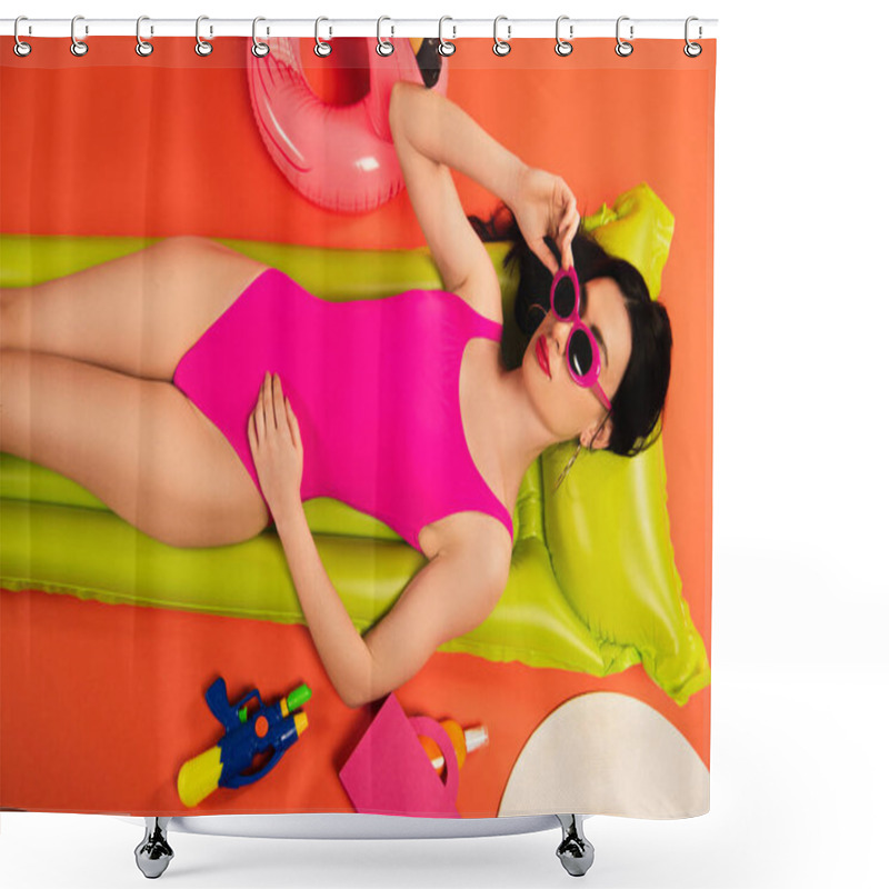 Personality  Top View Of Stylish Girl In Sunglasses And Swimsuit Lying On Inflatable Mattress Near Inflatable Ring And Water Gun On Orange Shower Curtains