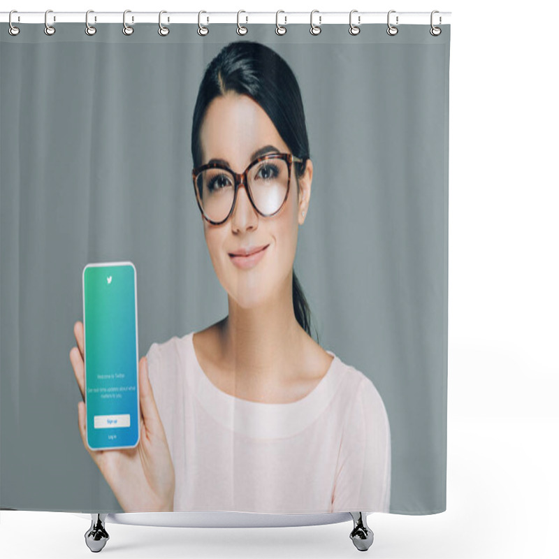 Personality  Portrait Of Smiling Woman In Eyeglasses Showing Smartphone With Twitter App On Screen Isolated On Grey Shower Curtains