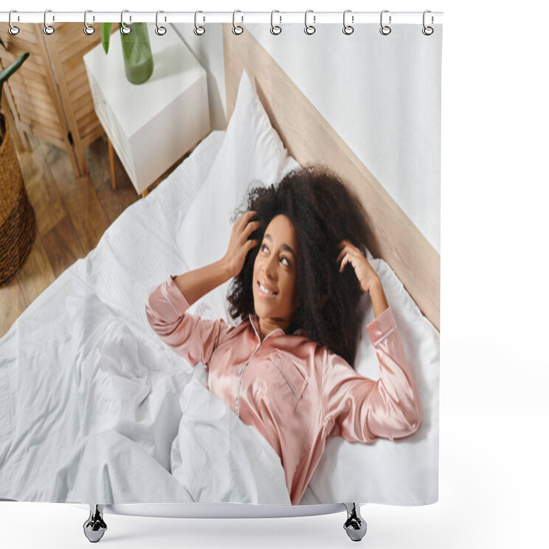 Personality  A curly African American woman in pajamas peacefully laying on top of a white bed in the morning. shower curtains