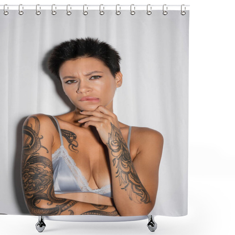 Personality  Displeased Tattooed Woman In Blue Satin Bra Biting Lip And Touching Chin While Looking At Camera On Grey Background Shower Curtains