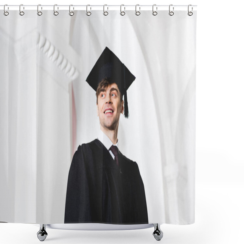 Personality  Low Angle View Of Happy Young Man In Graduation Cap Smiling In University  Shower Curtains