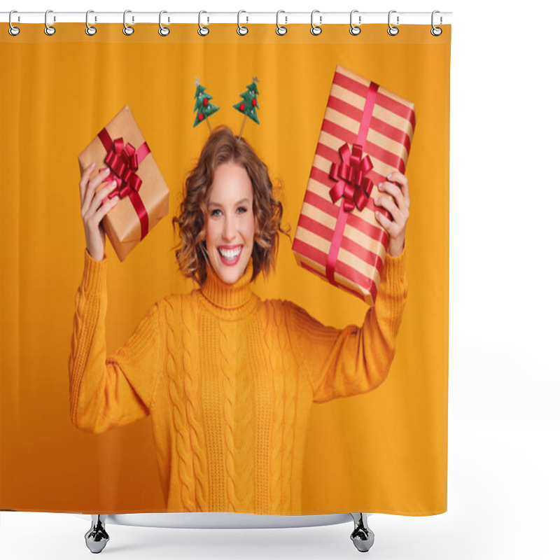 Personality  Happy Young Woman In Sweater And Headband Showing Wrapped Gifts And Looking At Camera With Smile On Christmas Day Against Yellow Backgroun Shower Curtains