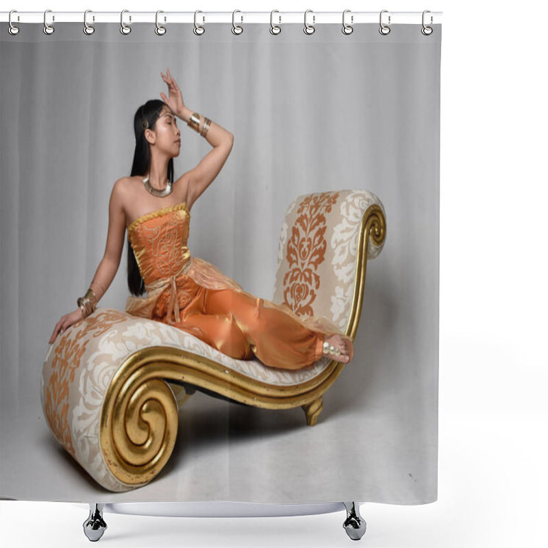 Personality  Full Length Portrait Of Pretty Young Asian Woman Wearing Golden Arabian Robes Like A Genie, Seated Pose On Lounge, Isolated On Studio Background. Shower Curtains