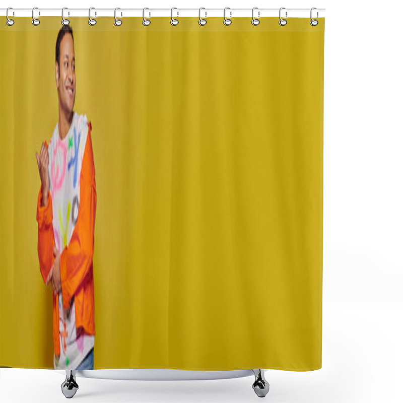 Personality  Positive Indian Man In Orange Jacket And Diy T-shirt Pointing With Thumb On Yellow Backdrop, Banner Shower Curtains