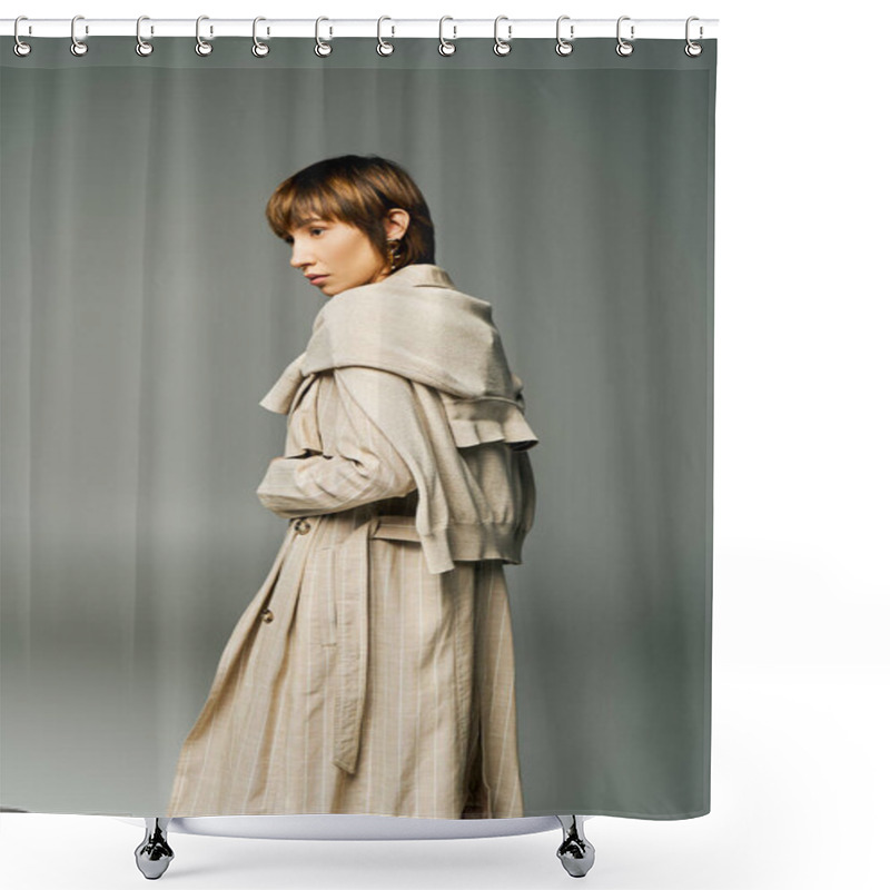 Personality  A Young Woman With Short Hair Stands Confidently In A Trench Coat Against A Solid Gray Background. Shower Curtains